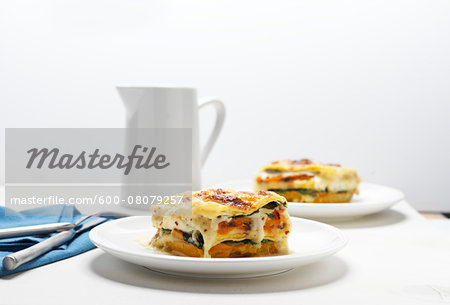 Lasagne on White Plates with Pitcher, Studio Shot
