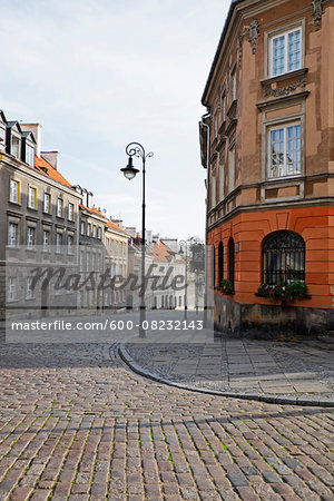 Old buildings and lamp post on cobblestone street corner, Old Town, Warsaw, Poland.