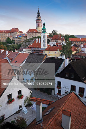 Overview of city and rooftops with the tower of St Jost Church and the tower of Cesky Krumlov Castle in the background, Cesky Krumlov, Czech Replublic.