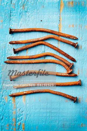 Close-up of Rusty Nails on Painted Wood