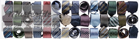 Assortment of ties rolled-up on white background in studio Assortment of ties rolled-up on white background in studio