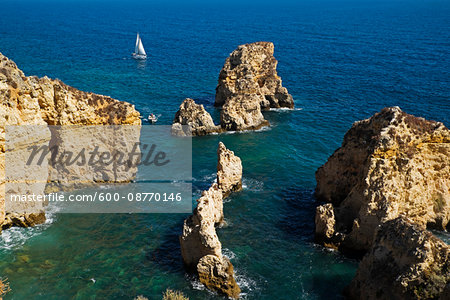 Sailboat and Rock Formations at Lagos, Algarve Coast, Portugal