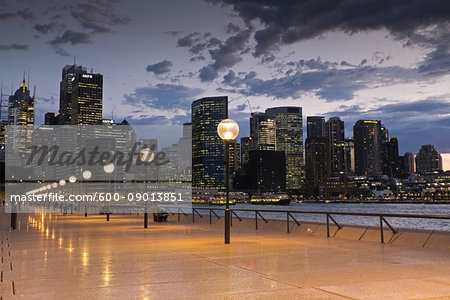 Seaside Promenade and Sydney skyline at dusk at the Circular Quay in Australia Seaside Promenade and Sydney skyline at dusk at the Circular Quay in Australia