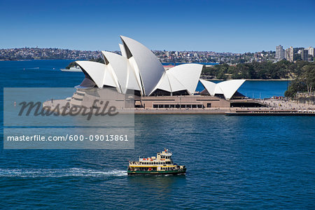 Ferry crossing Sydney Harbour with the Sydney Opera House on a sunny day in Sydney, Australia