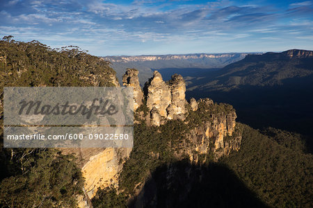 Sunlight reflecting on the Three Sisters rock formations and scenic view of the Blue Mountains National Park in New South Wales, Australia