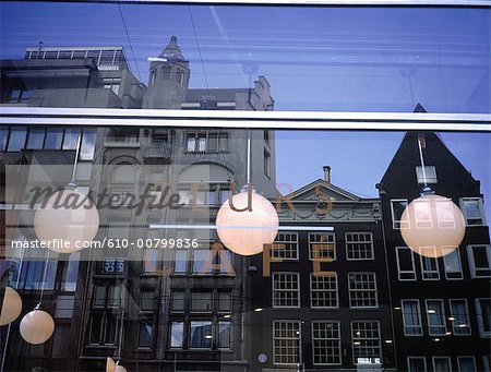 The Netherlands, North Holland, Amsterdam, traditional dwellings reflected on a cafe window