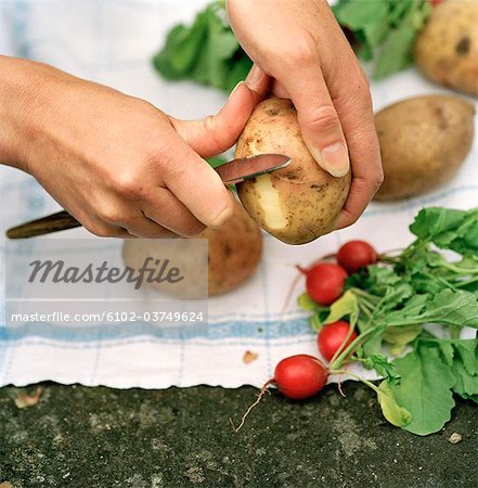 Peeling potatoes.