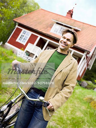 A man holding a bike.