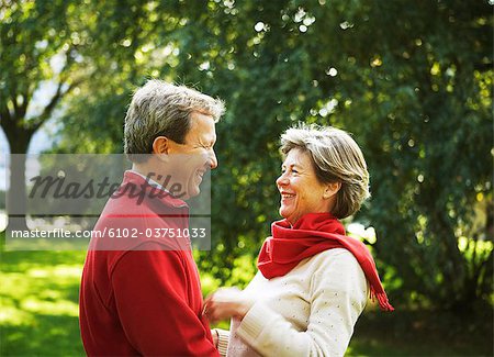 Portrait of a middle aged couple looking at each other.