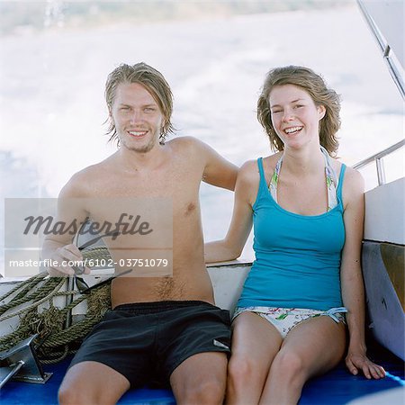 Young couple in a motorboat, Thailand.