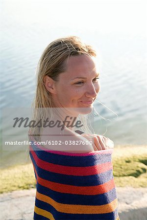 A woman wit a towel wrapped around herself, Ostergotland, Sweden.