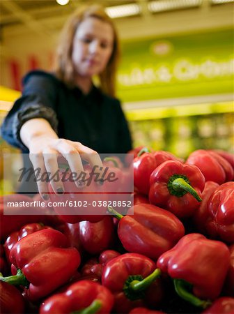 A woman buying sweet pepper, Sweden.