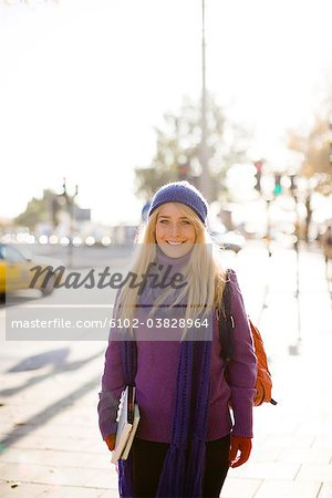 A woman walking in street in autumn, Stockholm, Sweden.