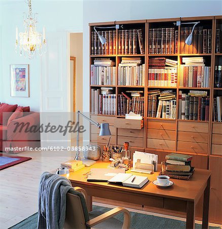 Home Interior With Study Table And Wooden Bookshelf Stock Photo