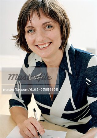 Portrait of smiling woman sitting at desk