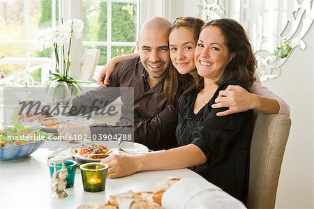 Portrait of a family at a dinner table, Sweden.
