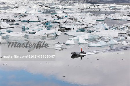 Boats in sea with ice around