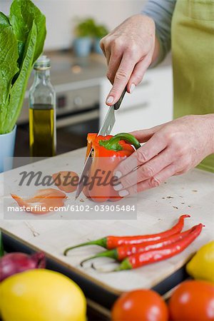 Woman cutting up vegetables, Sweden.