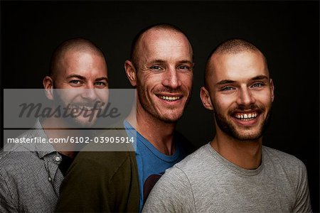 Three men standing, smiling, portrait