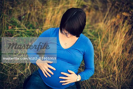 Pregnant woman touching stomach