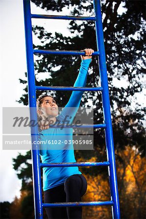 Woman climbing on ladder