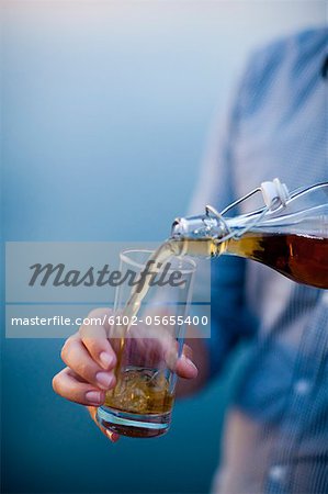 Man pouring wine into glass, close-up