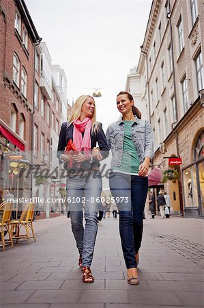 Two Women Walking Arm In Arm In Street Stock Photo Masterfile Premium Royalty Free Code 6102