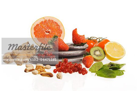Various fruits and vegetables on weights, studio shot