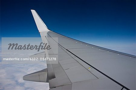 Plane wing against blue sky