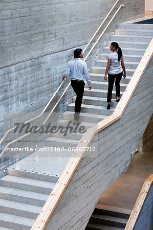 Man and woman walking on stairs