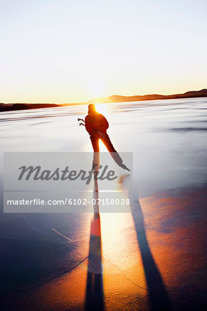 Woman long-distance skating at sunset
