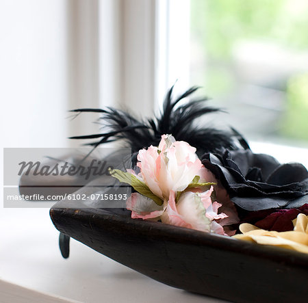 Fake flowers on window sill, close-up