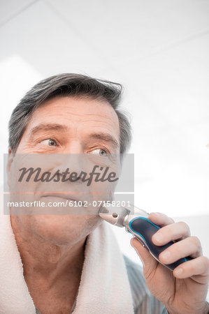 Mature man shaving