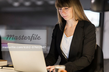 Young woman working on laptop in office, Stockholm, Sweden