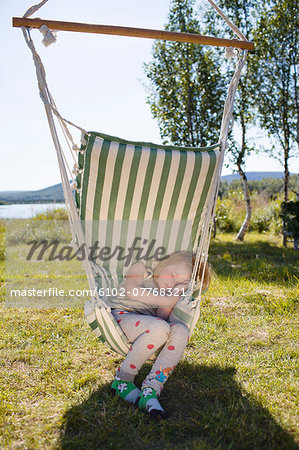 Girl sleeping on hammock, Kiruna, Lapland, Sweden