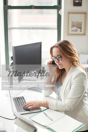 Mid adult woman in office, New Jersey, USA