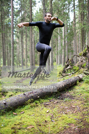 Mid Adult Man Running Through Forest Stock Photo Masterfile Premium Royalty Free Code 6102