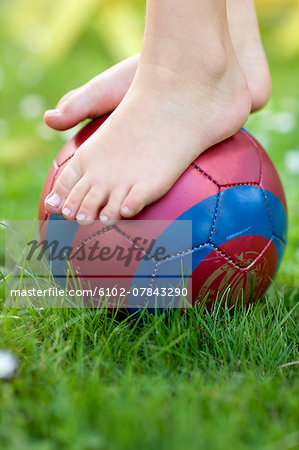 Childs feet on ball, close-up