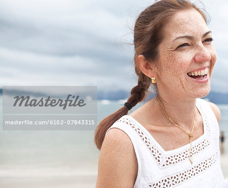 Smiling young woman on beach