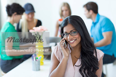 Smiling woman talking via cell phone