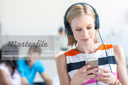 Woman listening music on cell phone
