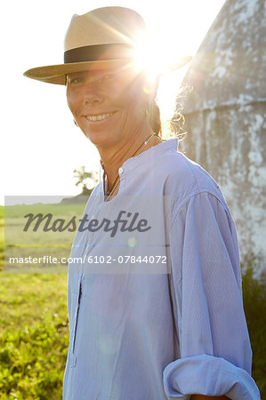 Mature woman wearing sun hat looking at camera