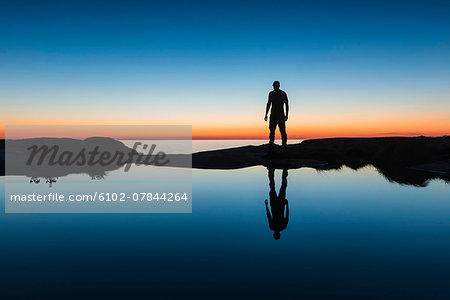 Silhouette of man at coast