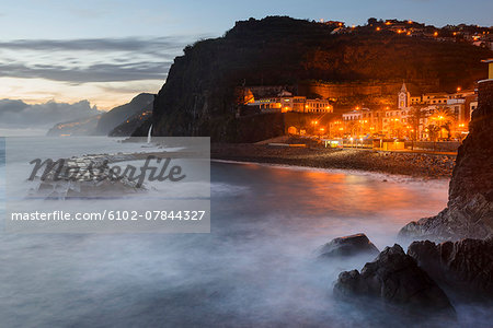 Illuminated town on rocky coast Illuminated town on rocky coast