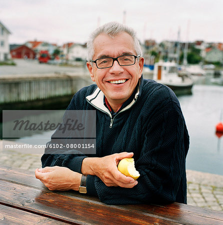 Smiling senior man at water