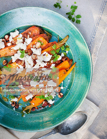 Roasted carrot with feta cheese on plate