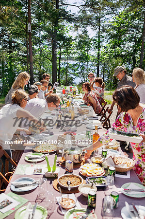 Family having meal outdoors Family having meal outdoors