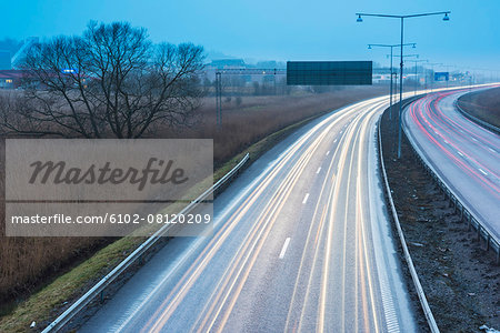 Car lights on road at dusk