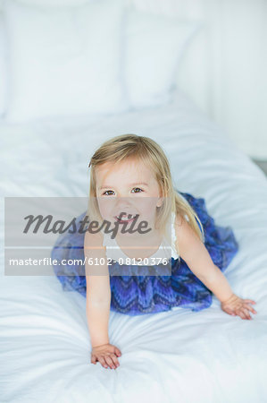 Girl playing on bed