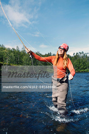 Woman fly fishing Stock Photos, Royalty Free Woman fly fishing